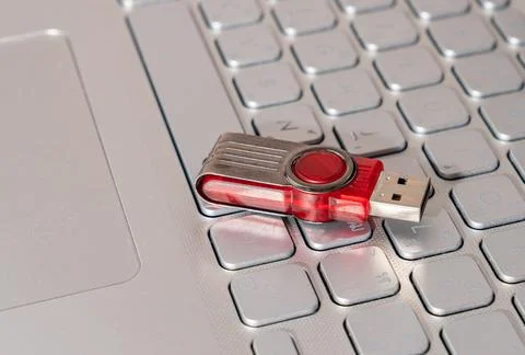 Thumb drive on notebook. Concept of copying data. Stock Photos