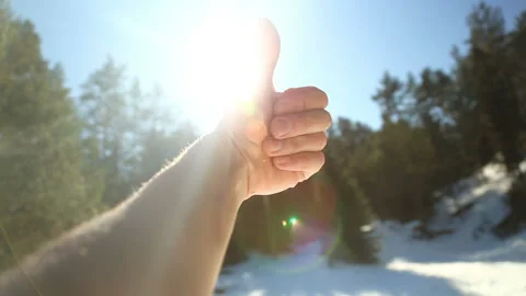 Thumb up facing the sun Stock Footage 125617590