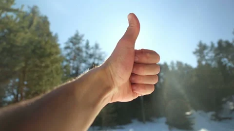 Thumb up facing the sun Stock Footage 125617735