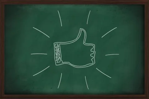 Thumb up on the green chalkboard Stock Illustration