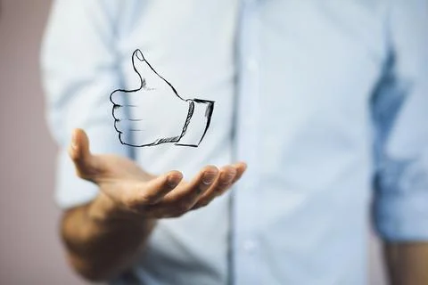 Thumb up on man hand Stock Photos