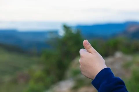 Thumb up on the mountain Stock Photos
