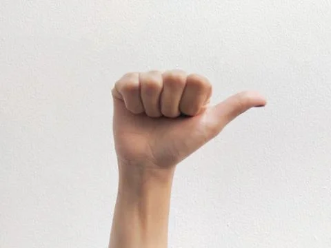 Thumb pointing towards the side Stock Photos