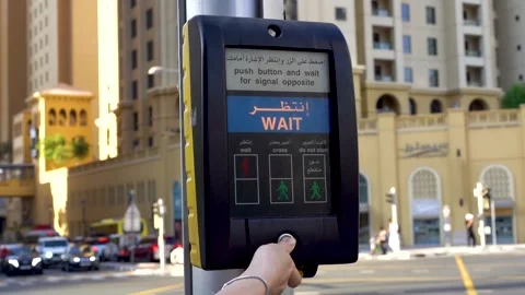 The thumb presses the crosswalk button. Light up the word WAIT Stock Footage 222192488