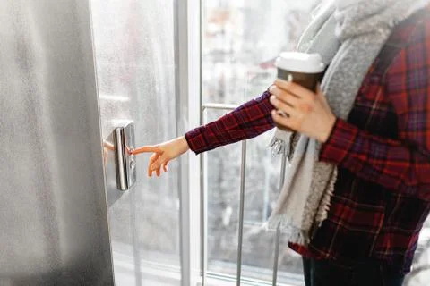 The thumb presses the Elevator button, a hand reaching for the button, the gi Stock Photos