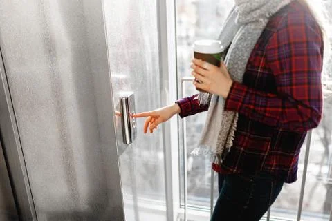 The thumb presses the Elevator button, a hand reaching for the button, the gi Stock Photos