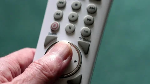 Thumb pressing the OK and direction buttons on tv remote control. Stock Footage 133597023