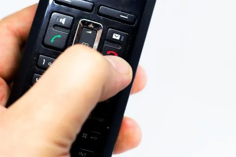Thumb pushing the button with the red icon to reject or hang up a call Stock Photos