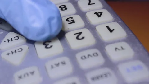 Thumb Pushing TV Remote Buttons, Hand In Protective Gloves, Close Up Video stock 142874448