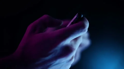 Thumb scrolling on a smartphone in landscape close up in a dark room side pr Video stock 137103834