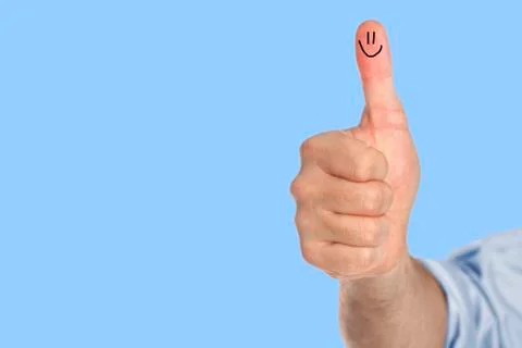 Thumb up with a smile Stock Photos