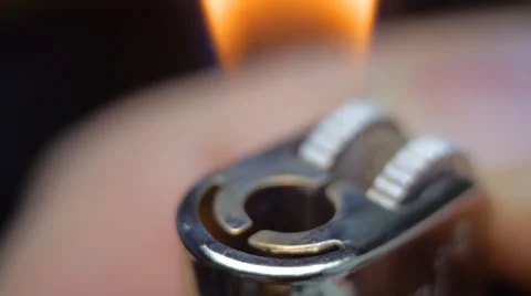 The thumb spin the wheel in lighter and ignites the gas. Macro Stock Footage 61550747
