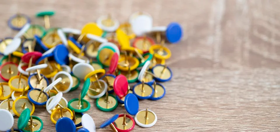 Thumb tacks on the table Stock Photos