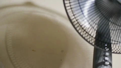 Thumb Turning On Electric Fan with Rotating Shadow on Wall Stock Footage 339013129
