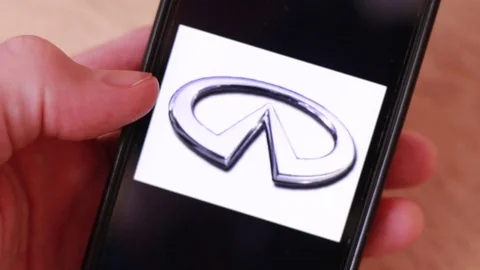 Thumbing through car brands logos on smartphone 動画素材 83533037