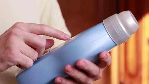 Thumbing through the instruction on the bottle with detergent 動画素材 83949859