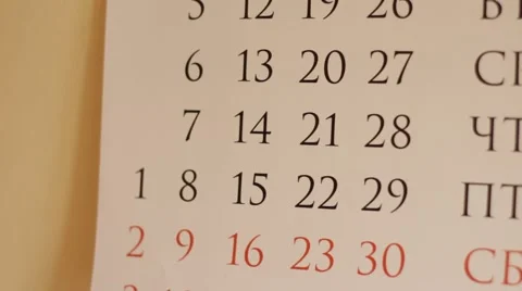 Thumbing through the wall calender Stock Footage 68991495