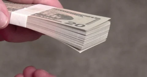 Thumbing thru Stack of Twenty Dollar Bills Stock Footage 122213556