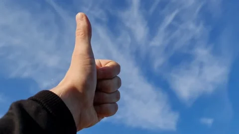 Thumbs up against the sky. Class. Super. Hand gesture. Stock Footage 157566435