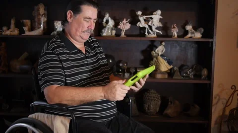 THUMBS-UP BY DISABLED-PARAPLEGIC: man with tablet computer in wheelchair. Stock Footage 45437855