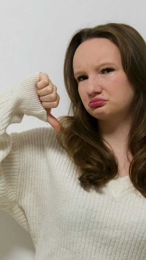 Thumbs down Close-up upset young woman showing thumbs down waving head no Video stock 294971250