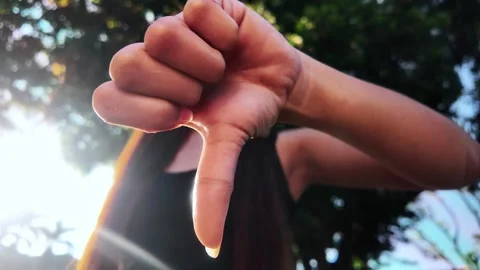 Thumbs Down Hand Gesture Front View Low Angle Close Up Outdoors in Nature Stock-Footage 323272299
