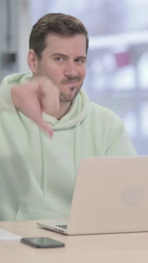 Thumbs Down by Man Working on Laptop, vertical video 動画素材 329104928