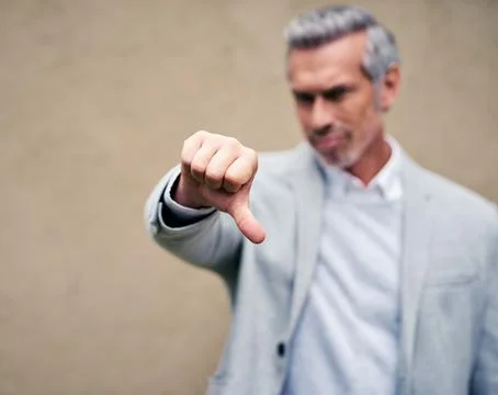 Thumbs down to not looking presentable all the time. a smartly dressed mature Stock Photos