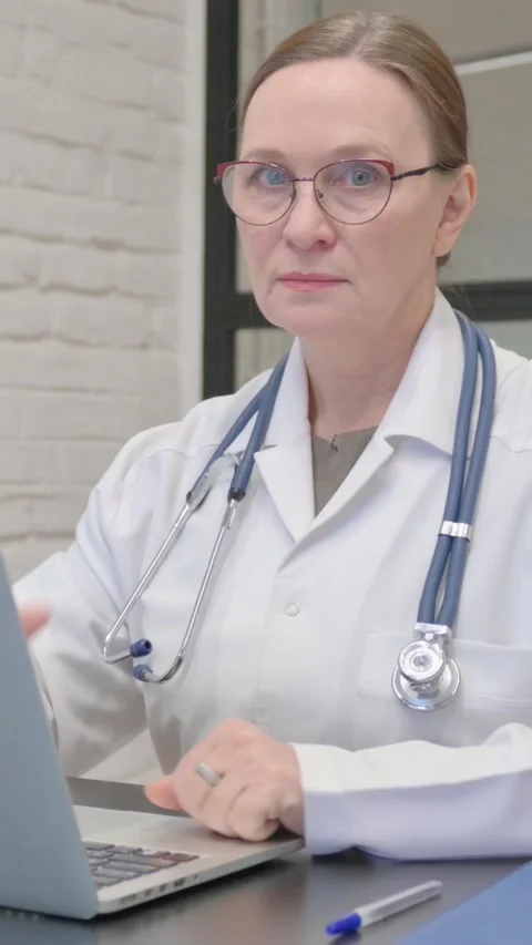Thumbs Down by Old Lady Doctor Using Laptop, vertical video Vídeo Stock 325708152