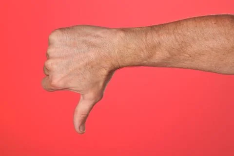 Thumbs down sign on red background Stock Photos