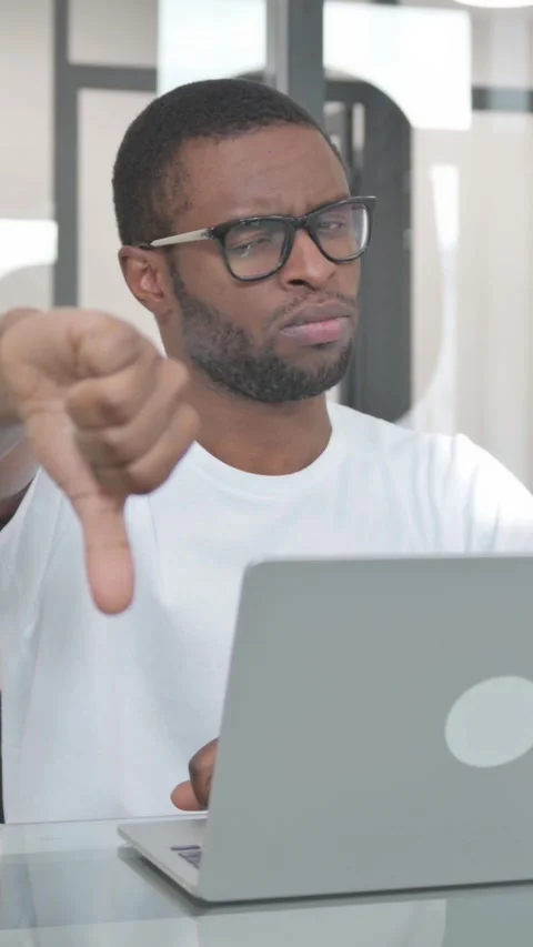 Thumbs Down by Young African Man Using Laptop, vertical video Stock Footage 324690510