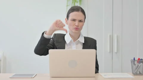 Thumbs Down by Young Businesswoman Working on Laptop Stock Footage 233385953