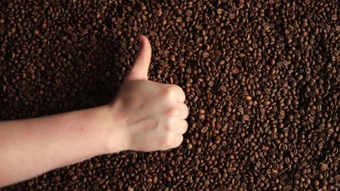 Thumbs Up Gesture Over Roasted Coffee Beans Background Stock Footage 338441330