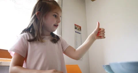 Thumbs up gilrl in the kitchen Stock Footage 143507490