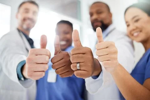 Thumbs up, hands and doctors with nurses in hospital for agreement on medic.. Stock Photos