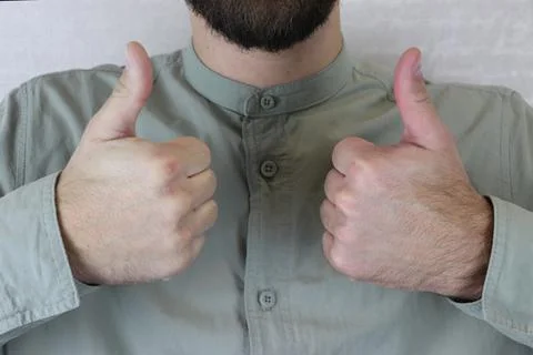 Thumbs up on the hands of a man Stock Photos