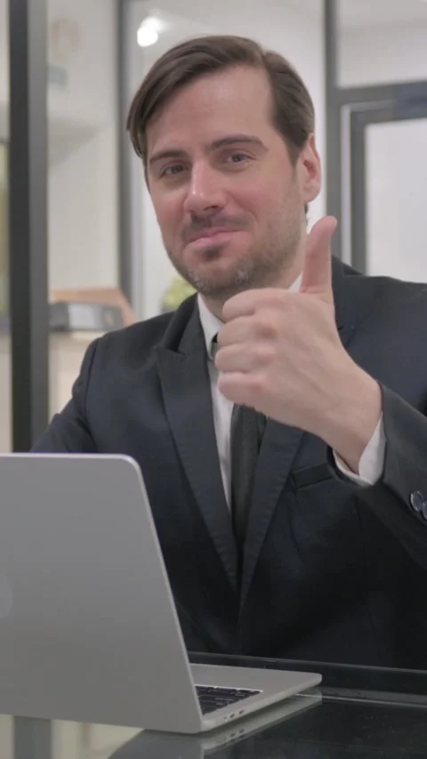Thumbs Up by Middle Aged Businessman at Work, vertical video Video stock 325568657