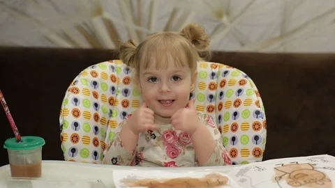Thumbs up. Ok. Beautiful two years old girl. Cute blonde child. Brown eyes Stock Footage 87326495