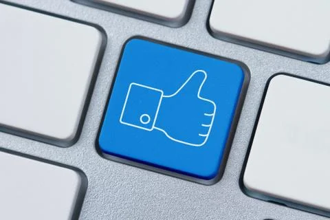 Thumbs up or like symbol at the computer key Foto stock