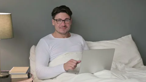 Thumbs Up Sign by Middle Aged Man with Laptop in Bed Stock Footage 142367747