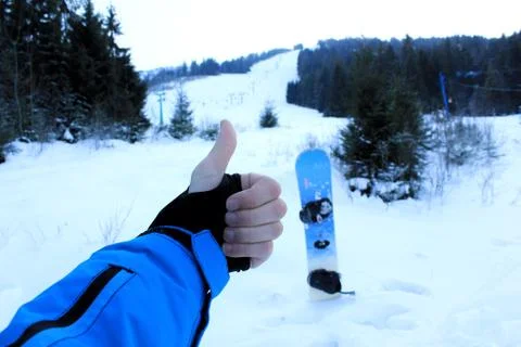 Thumbs up with snowboard view Stock Photos