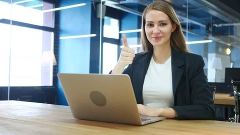 Thumbs Up by Woman at Work Stock Footage 72003030