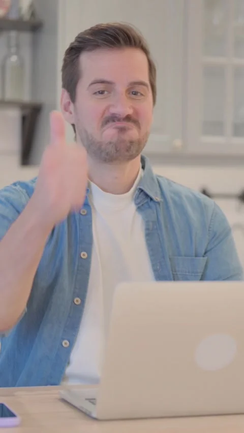 Thumbs Up by Young Man on Laptop, vertical video Stock Footage 328565789