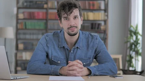 Thumbs Up by Young Man at Work Looking at Camera Stock Footage 102026430