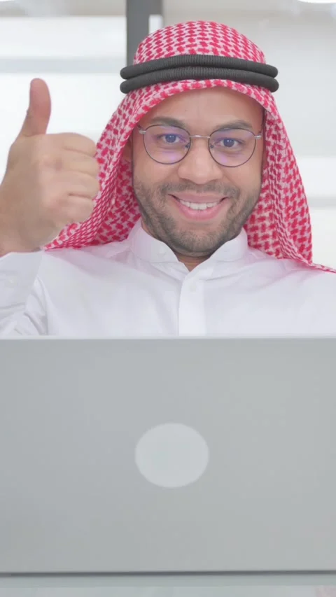 Thumbs Up by Young Muslim Man at Work, vertical video Video stock 325567995