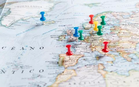 Thumbtacks pinned to a map of Europe. Stock Photos