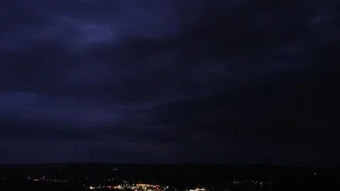 Thunder and lightning in a storm cloud-filled night sky Stock Footage 205247807