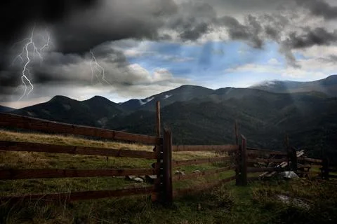 Thunder cloud with lightnings over mountains. Severe weather Stock Photos
