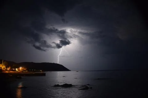 Thunder crashing down on hillside next to the sea in Mount Athos Stock Photos