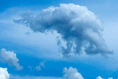 Thunder storm cloud on a blue sky background, dramatic cloudscape moody backg Stock Photos